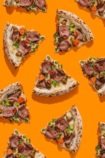 Top view of delicious pizza slices, tastefully topped with roast beef, truffle sauce, mozzarella,