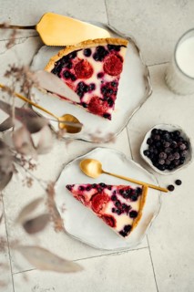 Top view of a delicious slice of berry clafoutis pie filled with vibrant blackcurrants and