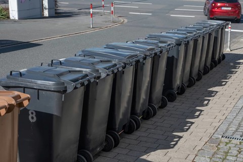 Garbage bins lined up on the street ready for collection, Eckental, Middle Franconia, Bavaria,