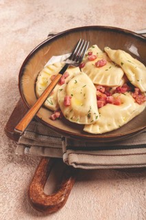 Dumplings, with fried prosciutto, a traditional dish of Polish cuisine, dumplings, top view,