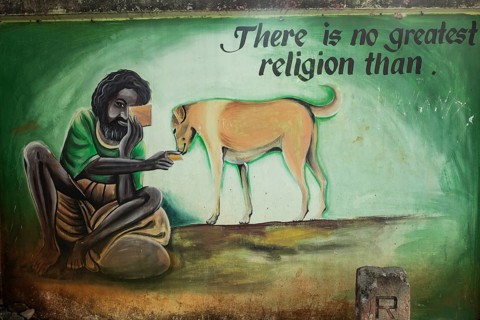 Mural painting depicting a poor man feeding a stray dog (Odisha, India), mural promoting animals