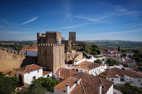 Elevated view of Obidos Castle in Obidos, Portugal, with stone walls, tiled rooftops, white houses