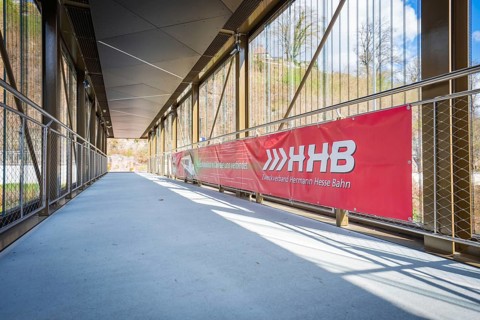 Sunny footbridge with modern architecture under blue sky, Hermann Hesse Bahn, ZOB, Calw, Germany