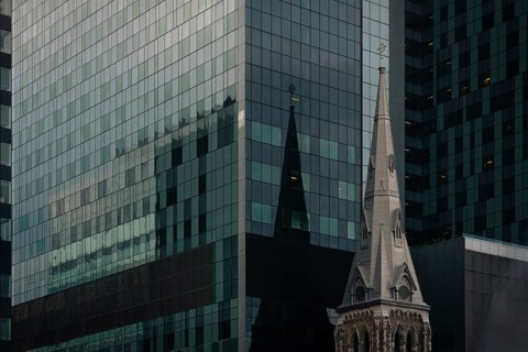 A striking juxtaposition of Montreal's urban landscape featuring a modern glass skyscraper