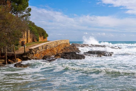 Wooden walkway destroyed by the sea, east coast in Cala Ratjada, Majorca, Spain