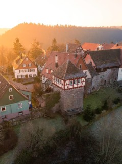 Historic half-timbered houses and a tower in a peaceful village at sunset, Zavelstein, district of