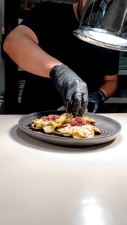 A chef expertly prepares a gourmet dish, showcasing finely chopped ingredients and culinary