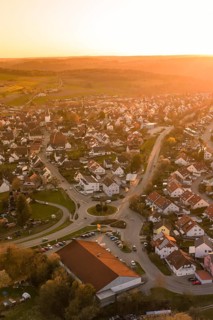 View of the center of a village with a roundabout in warm sunset light, Calw, Stammheim, Calw