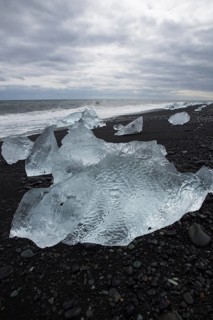 Little icebergs and crushed ice on the black beach at Joekulsarlon glacial lake