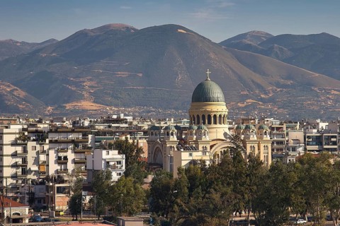 Church in the middle of an urban landscape with mountains in the background, Old ferry port in the