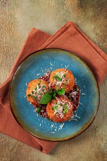 Crispy Arancini appetizer, with parmesan cheese and microgreens, plate, tomato sauce, homemade, no