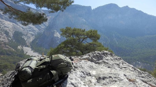 Rucksack on a rocky outcrop in front of a picturesque mountain panorama, hiking on the Lycian