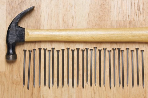 Hammer and Nails Abstract on Wood Background