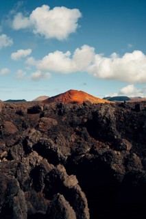 Stunning view of Lanzarote's volcanic terrain, showcasing dramatic rock formations with vibrant red