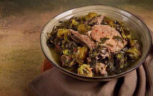 Chakapuli, Georgian dish, stewed meat with herbs and tkemali, in white wine, homemade, no people