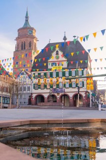 Square with bell tower and colourful pennants that convey a peaceful city atmosphere, Fasnet, Weil