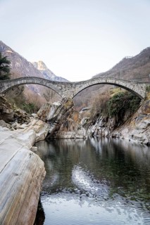 Scenic view of Ponte Dei Salti arching gracefully over the clear waters of the Verzasca River in