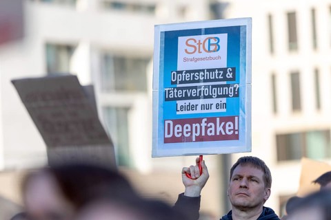 Berlin, Germany - 22.3.2026: Demonstrators, including one holding up a poster with the inscription: