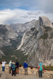 Yosemite National Park, California - Tourists view Half Dome in Yosemite National Park from Glacier