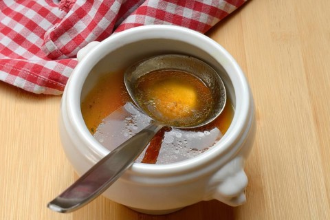 Bouillon, beef broth with ladle in bowl