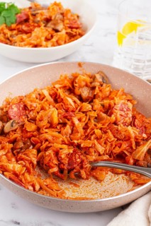Bigos, Polish dish bigos, on the table, pan with stewed meat, with cabbage, chorizo sausages,