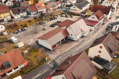 Residential buildings in a village with red tiled roofs, quiet atmosphere and roads in autumn