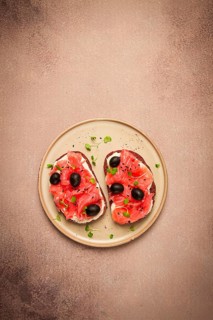 Sandwiches with red fish, cream cheese, olives and microgreens, breakfast