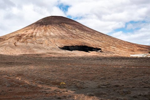 A stunning volcanic landscape located in Lanzarote, Canary Islands, Spain. The barren terrain and