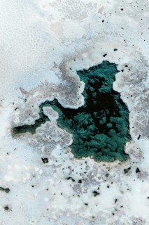 A captivating aerial view of salt ponds in La Puna, Argentina, showcasing diverse textures and