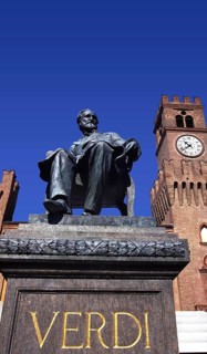 Verdi monument in front of Rocca dei Marchesi Pallavicino, now the city hall, with Teatro Giuseppe