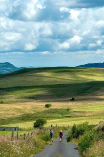 Hikers in Cezallier plateau in the Auvergne volcanoes regional natural park, Puy de Dome