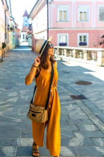 Young woman tourist exploring the charming streets of kranj, slovenia, during a sunny summer day