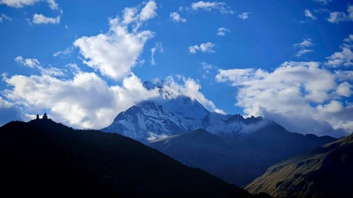 Snowy mountains with dramatic sky and clouds in the background Kazbek, Kazbegi, Stepantsminda,