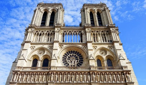 From below front view of the iconic Notre Dame Cathedral in Paris, France, showcasing its intricate