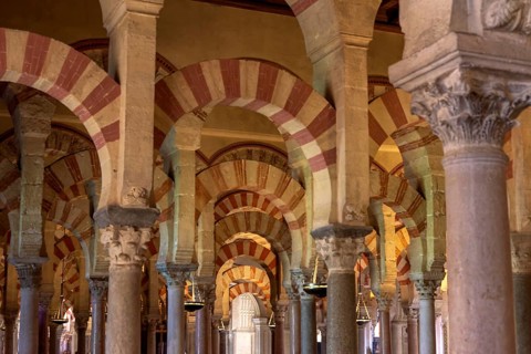 Columns and arches with red and white stripes in the cathedral mosque of Córdoba