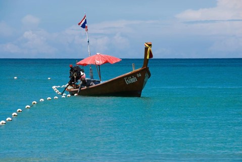 Typical Thai longtail boat on Bang Tao Beach in the northwest of the holiday island Phuket,