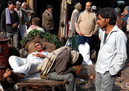 New Delhi, India, 14.01.10 - Market scene, day labourers resting on a sack truck, India