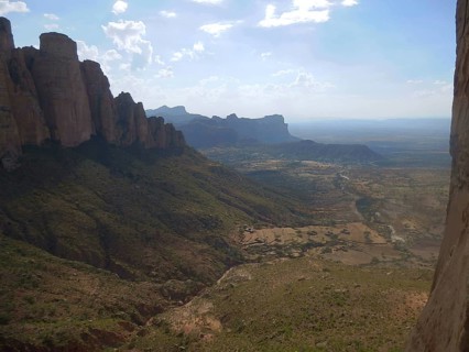 Breathtaking panoramic view of mountains and valleys in sunlight from Rock Church, Abuna Yemata