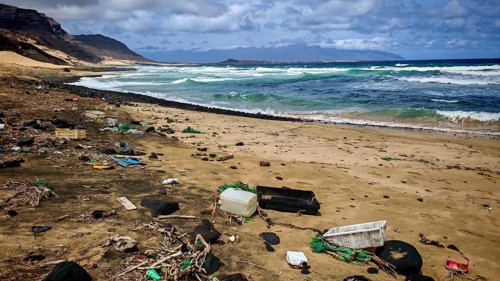 Waste and plastic waste, beach polluted with garbage and waves hitting the coast, Calhau migration,