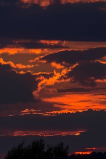 Red sun behind clouds in the evening sky, Mecklenburg-Vorpommern, Germany