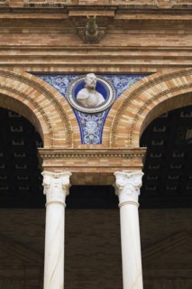 Bust of Hernan Cortes and painted ceramic tiles on arched brick and stone structure, Plaza de