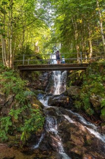 A mother with her child on a bridge at the Todtnau waterfall in the Black Forest in Germany