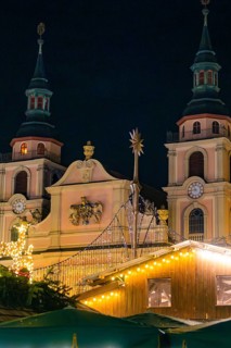 Two illuminated church towers at night with Christmas decorations in the foreground, Christmas
