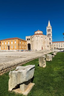Architectural remnants on display at Roman forum ruins with the church of Saint Donatus and Bell