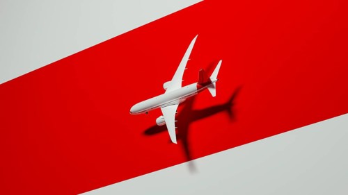 A sleek commercial airplane appears to soar gracefully against a striking red background. This