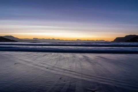 Ocean surf in sandy bay on the Norwegian European Sea at dusk, Söröya, Finnmark, December 2018