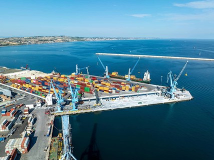 Aerial perspective of Ancona's bustling port, showcasing colorful cargo containers and towering