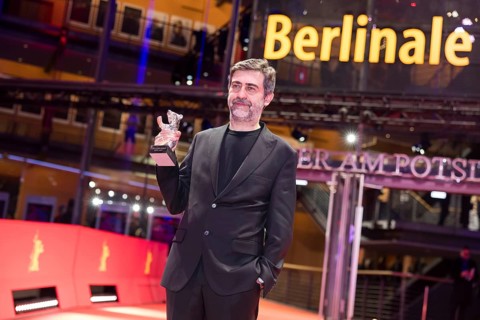 Emin Alper poses with the Silver Bear as director of the film Kurtulus (Redemption) after the award