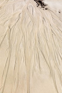 Seawater run-off leaves traces in the sand on Fazayat beach in Al Hauta, Dhofar province, Arabian