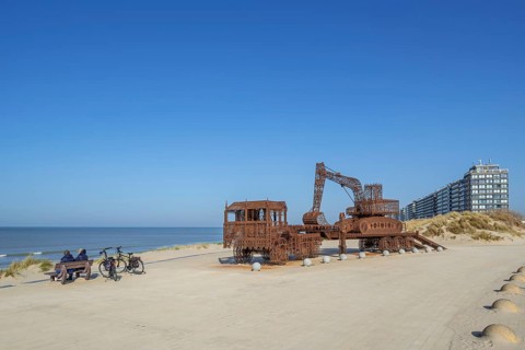 Caterpillar and Flatbed Trailer, artwork by Belgian neo-conceptual artist Wim Delvoye at seaside